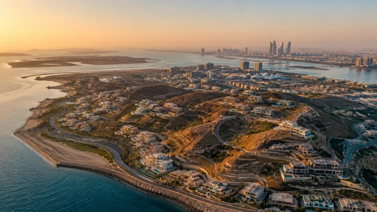 Aerial view of Hudayriyat Island in Abu Dhabi showing the Nawayef engineered hills, luxury waterfront villas, and master-planned smart-city development.